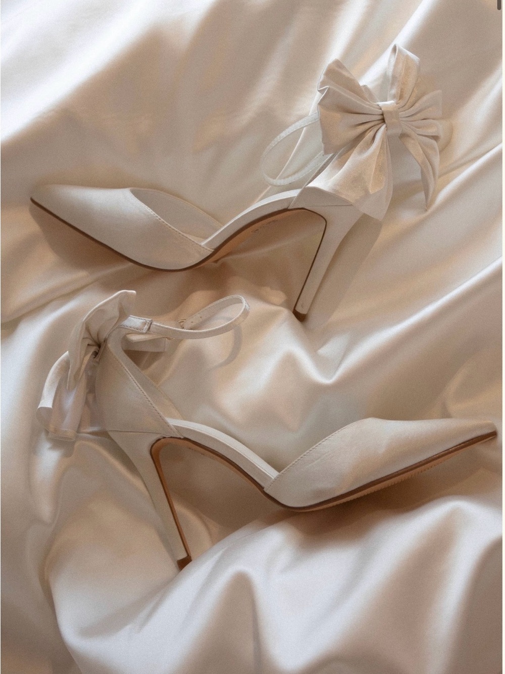 Meshki Ivory Satin Pointed-Toe Heels with Ankle Bow